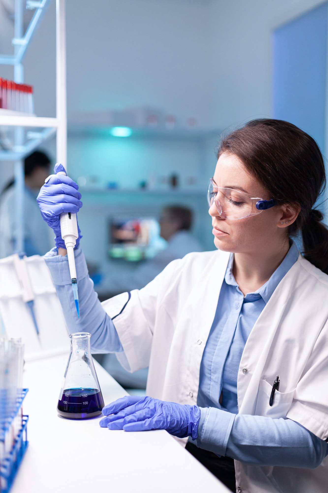 scientist-looking-into-micropipette-for-biology-test